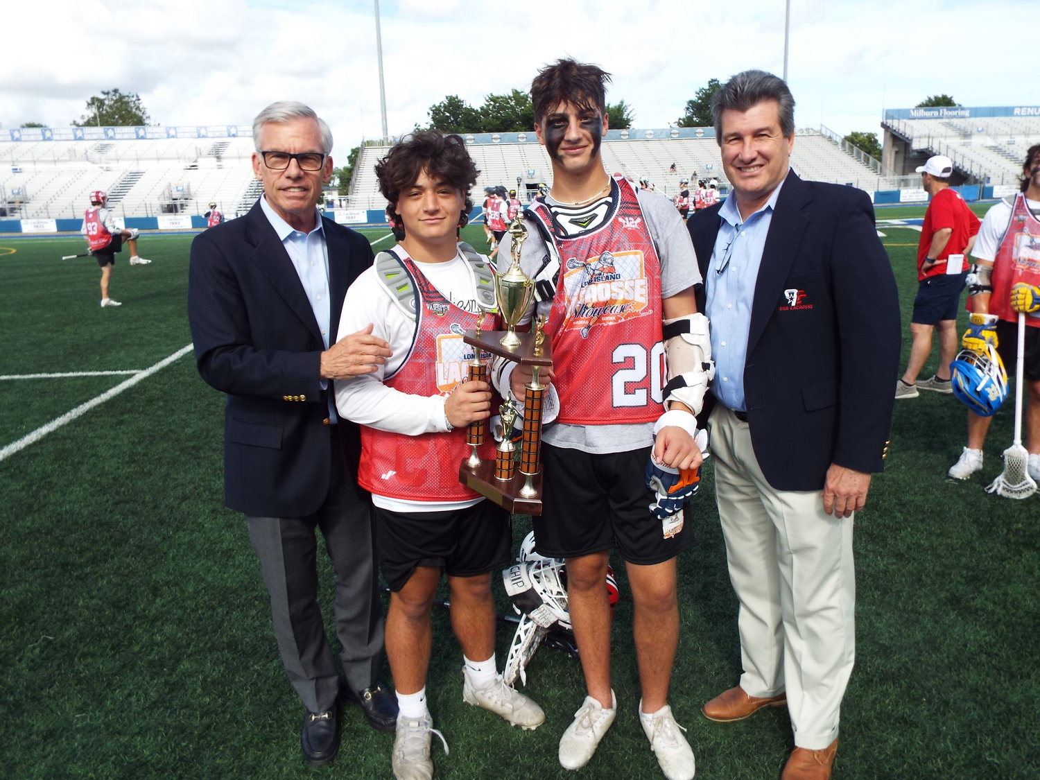 Drew Walendowski and Matthew Triolo received the Long Island Lacrosse Showcase Most Valuable Player Award from 1970s high school and college lacrosse stars James C. Metzger and Vincent J. Sombrotto. From left: Metzger, Walendowski, Triolo and Sombrotto.